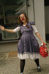 Eine Clownin winkt fröhlich in die Kamera beim Musikfestival Fête de la Musique auf dem Platz vor dem Immanuel Stadtteilzentrum Borsigwalde in Berlin-Reinickendorf.